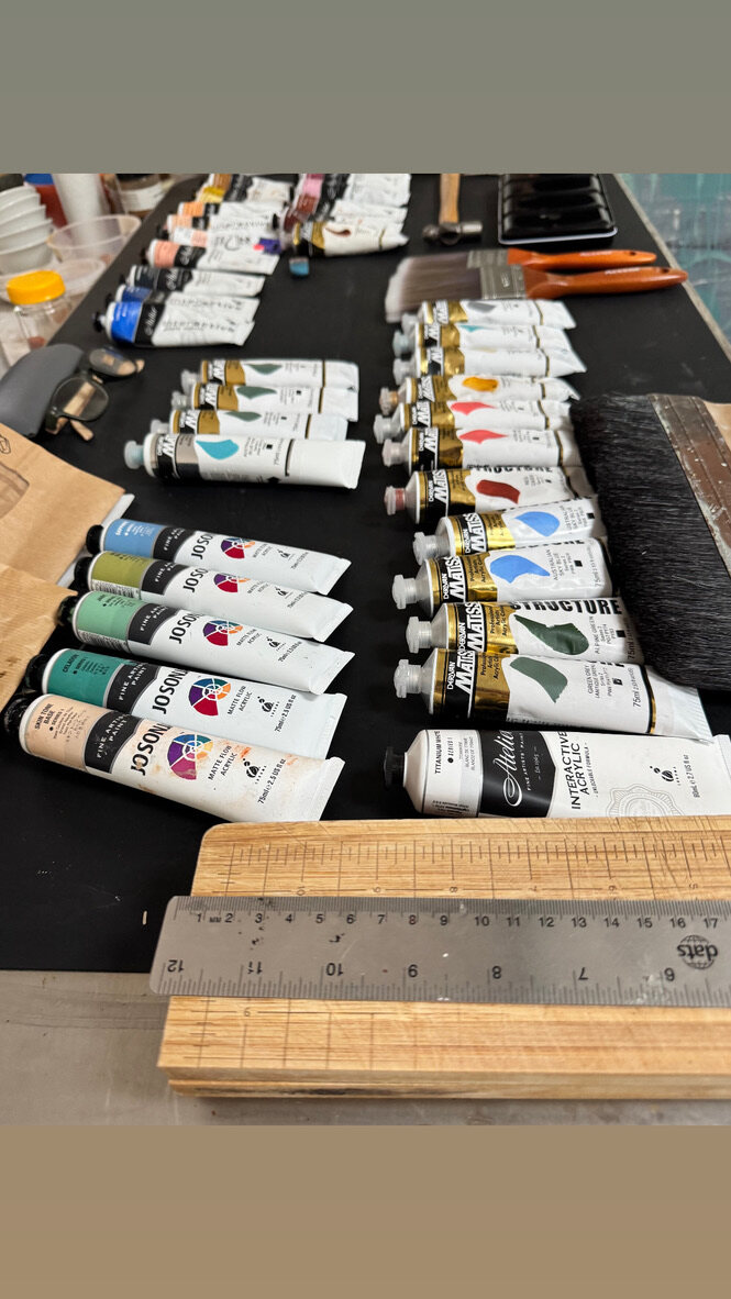 Studio paint table with tubes, jars and working materials